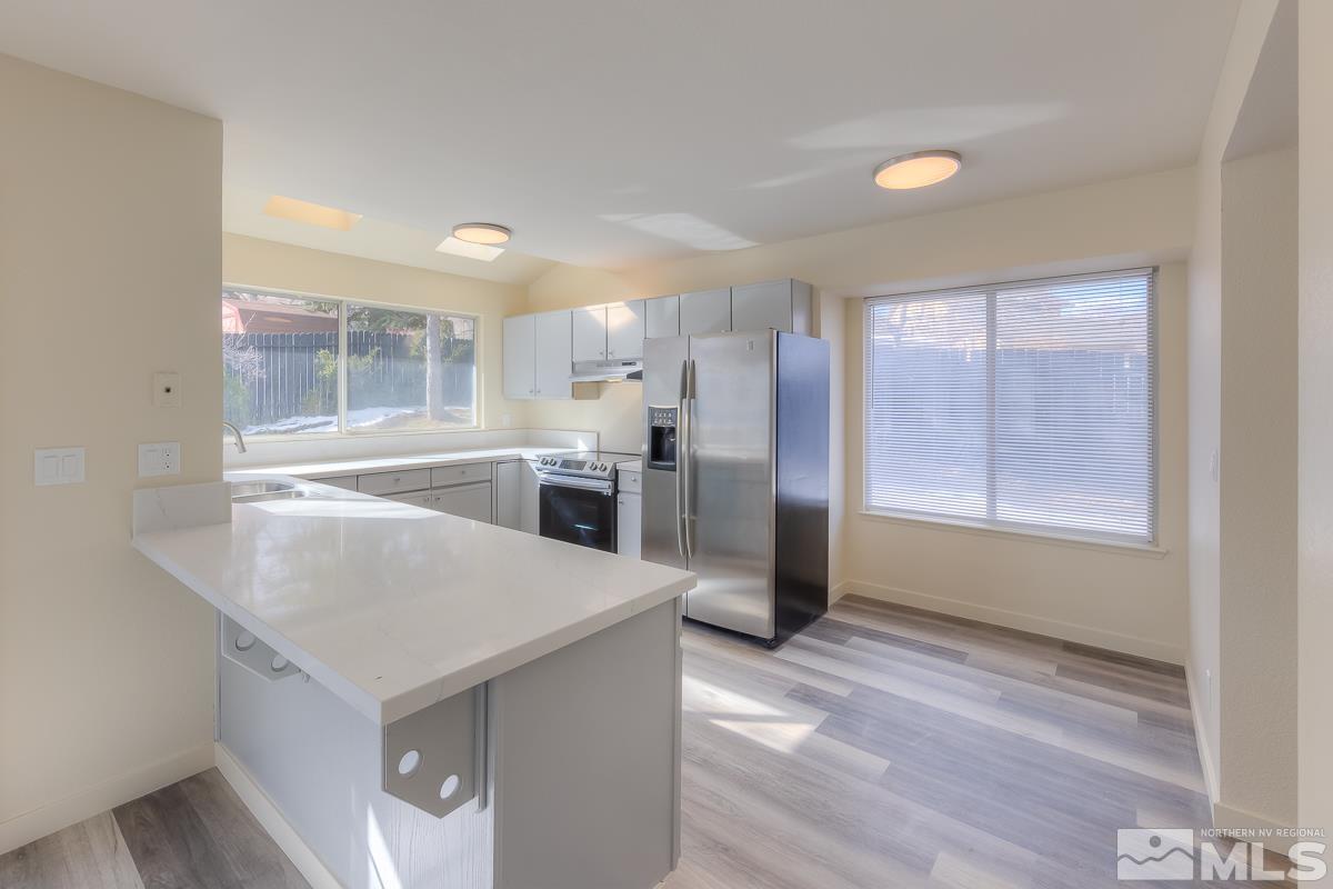 7196 Indigo Circle Reno, NV 89506 - Photo 24 of 33 a kitchen with a refrigerator a sink and a window