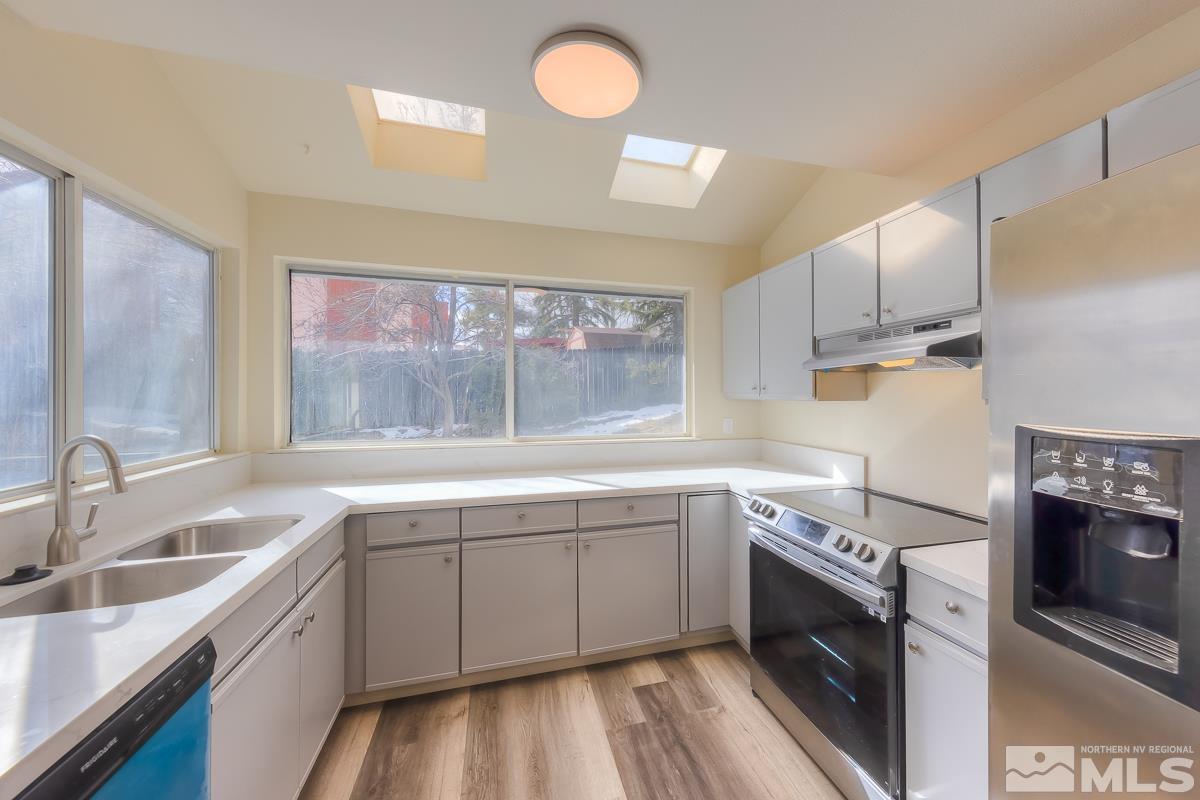 7196 Indigo Circle Reno, NV 89506 - Photo 33 of 33 a kitchen with a sink stove and refrigerator