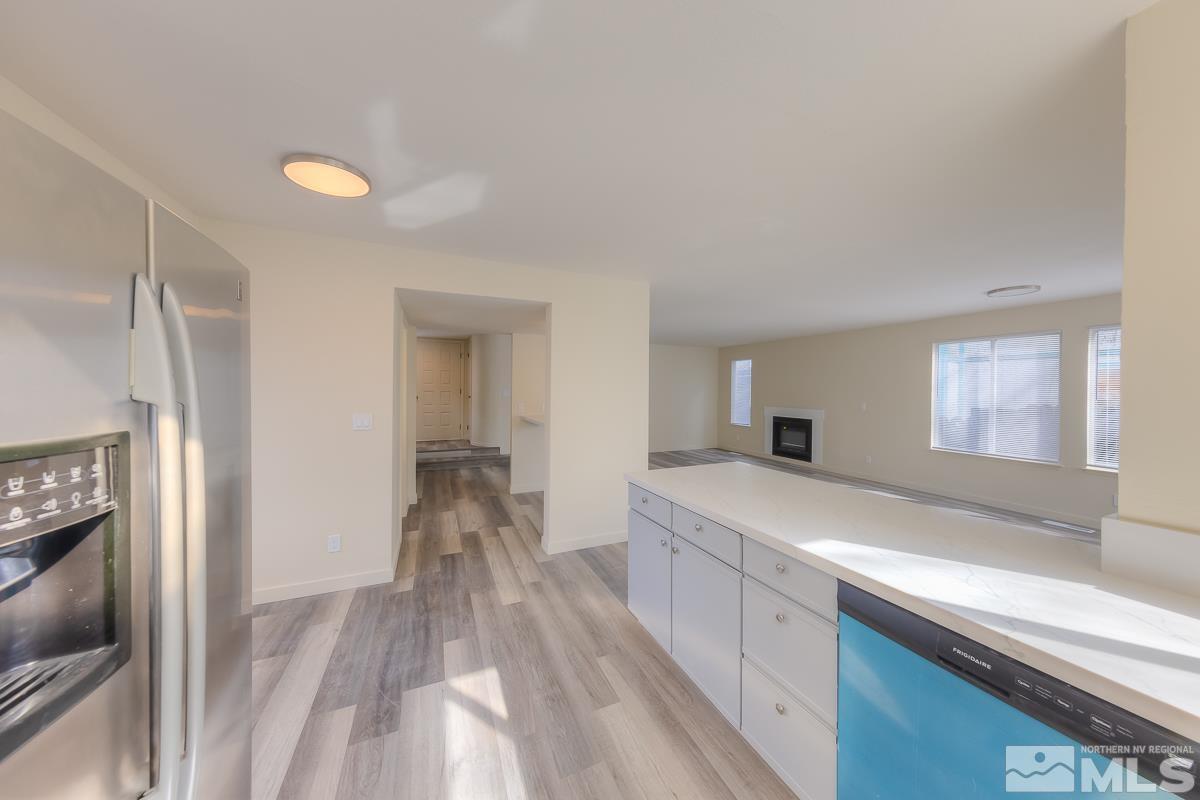 7196 Indigo Circle Reno, NV 89506 - Photo 5 of 33 a large kitchen with a sink and refrigerator