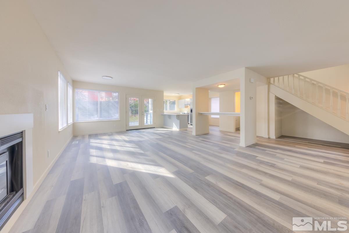 7196 Indigo Circle Reno, NV 89506 - Photo 9 of 33 a view of an empty room with wooden floor and a window
