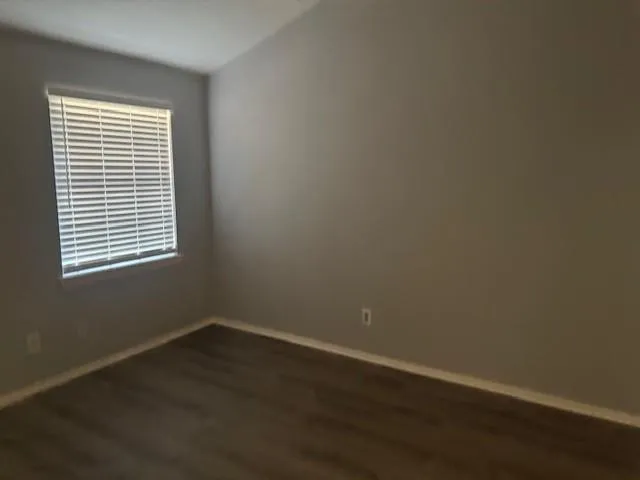 wooden floor and window in an empty room