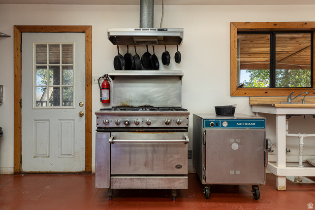 2040 North Long Cyn Road Kanab, UT 84741 - Photo 15 of 23 Kitchen with high end range, extractor fan, and concrete flooring