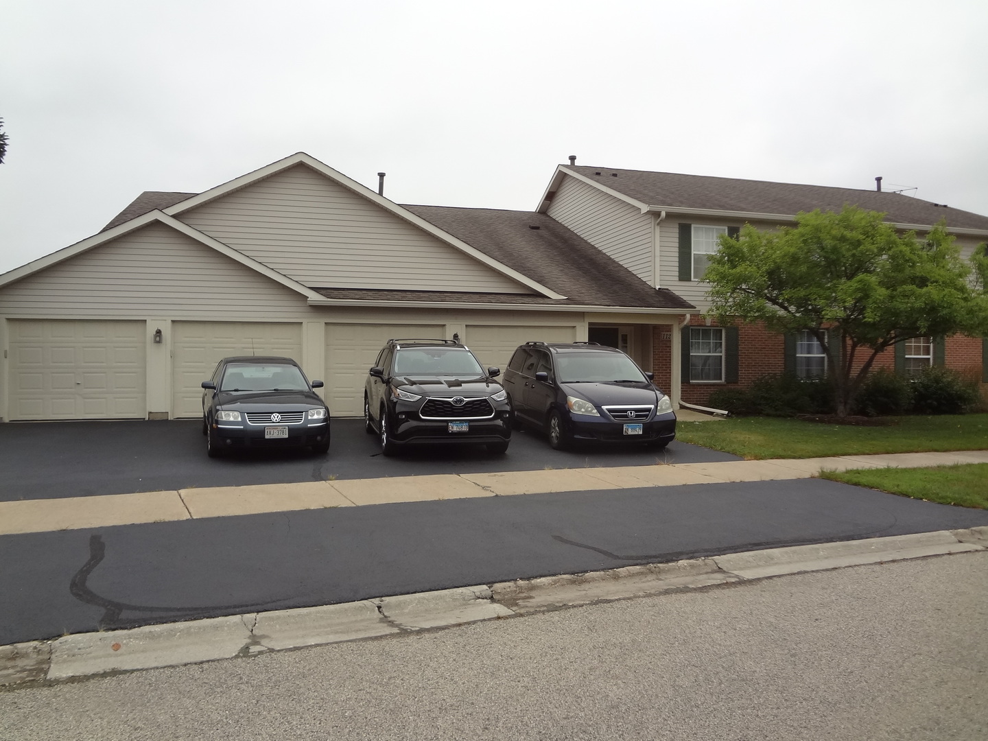 1127 North Red Oak Circle, Unit 4 Round Lake Beach, IL 60073 - Photo 1 of 31 a car parked in front of a house