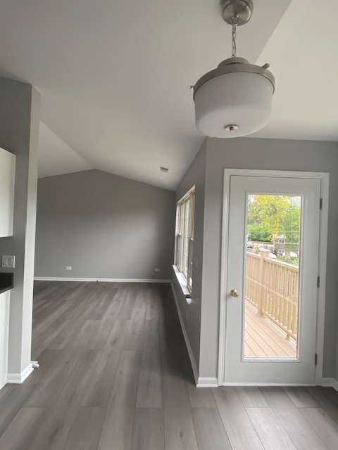 1127 North Red Oak Circle, Unit 4 Round Lake Beach, IL 60073 - Photo 24 of 31 an empty room with wooden floor and windows