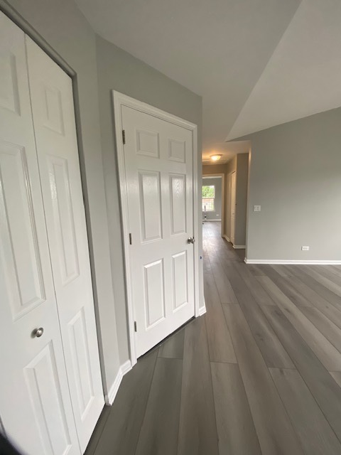 1127 North Red Oak Circle, Unit 4 Round Lake Beach, IL 60073 - Photo 26 of 31 a view of an empty room with wooden floor and a window