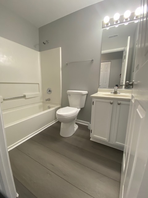 1127 North Red Oak Circle, Unit 4 Round Lake Beach, IL 60073 - Photo 29 of 31 a bathroom with a toilet a sink a mirror a bathtub and vanity