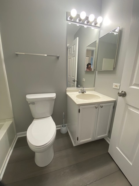 1127 North Red Oak Circle, Unit 4 Round Lake Beach, IL 60073 - Photo 30 of 31 a bathroom with a toilet sink and mirror