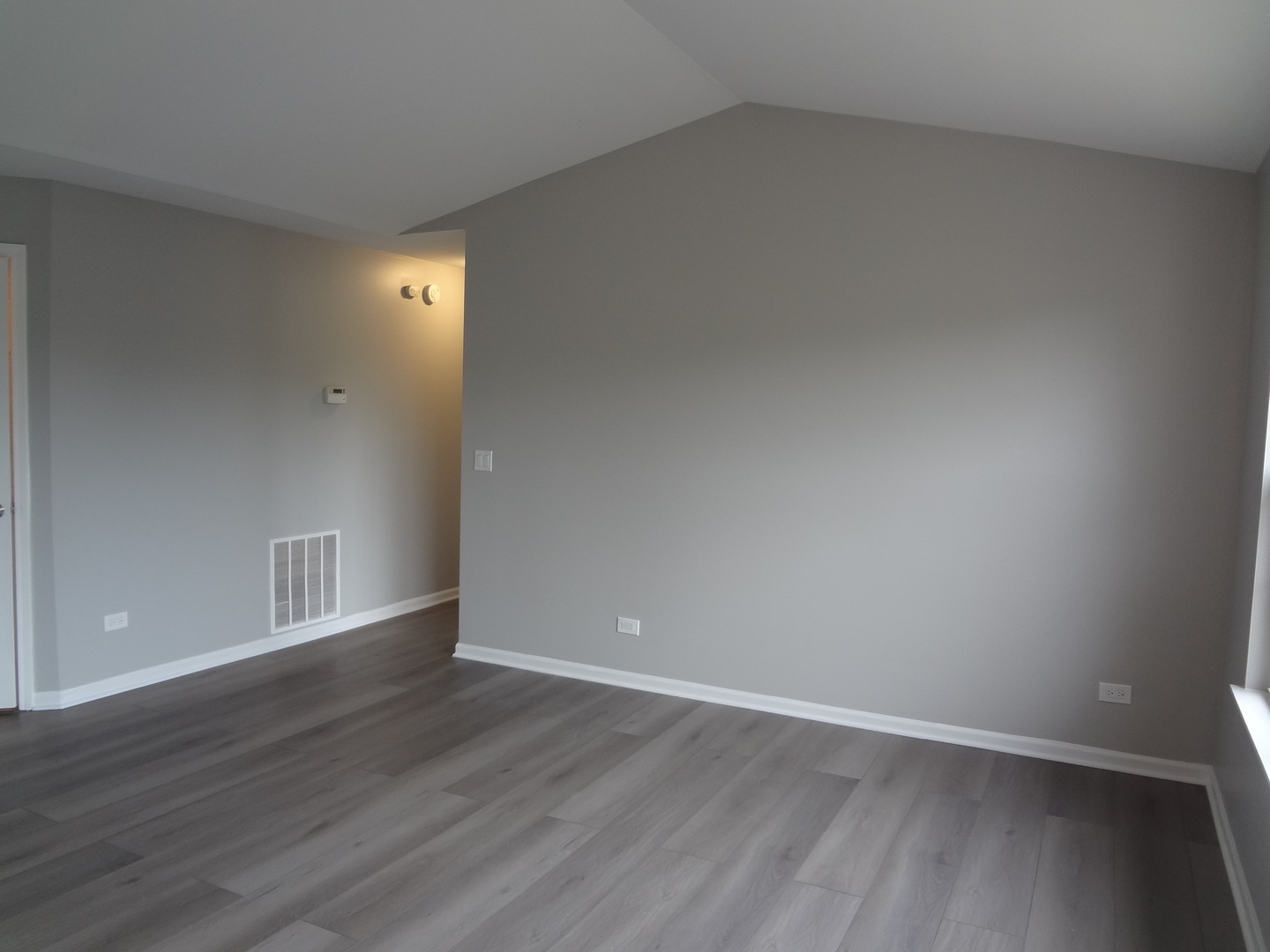 1127 North Red Oak Circle, Unit 4 Round Lake Beach, IL 60073 - Photo 4 of 31 a view of an empty room with wooden floor