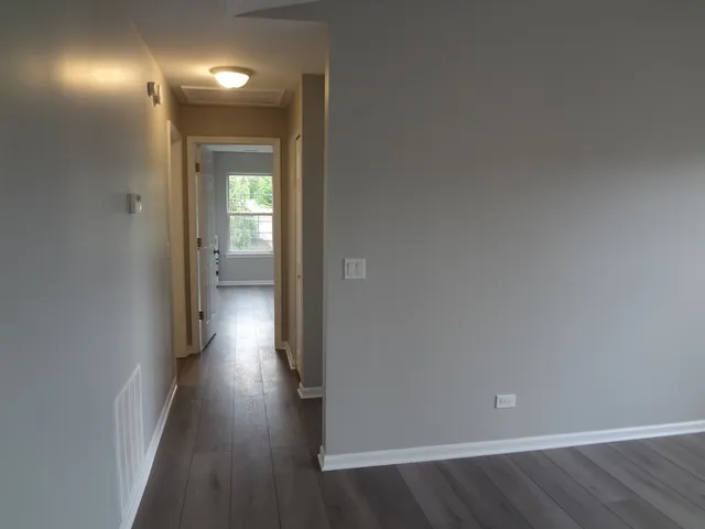 a view of hallway with wooden floor