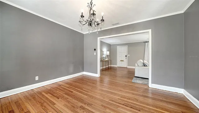 a view of a room with wooden floor and staircase
