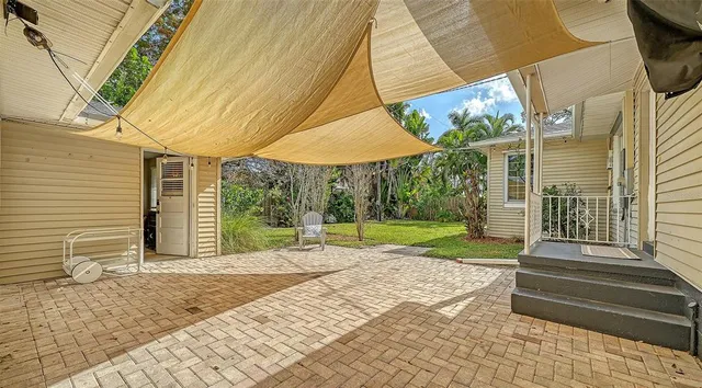 a view of a house with backyard and porch