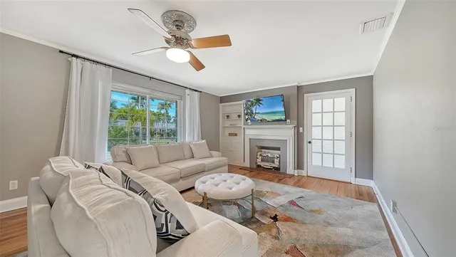 a living room with furniture a fireplace and a chandelier