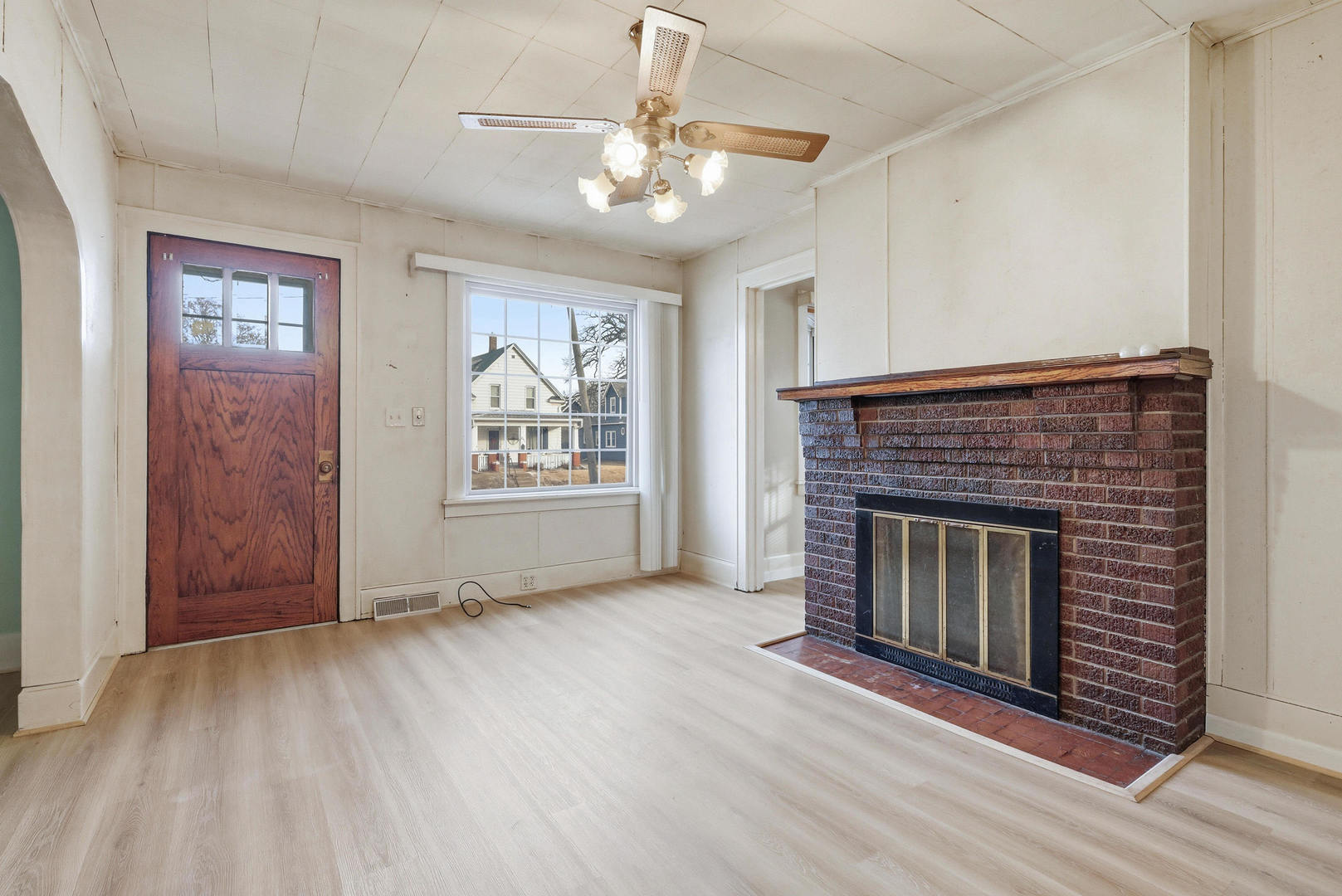 2748 12th Avenue Moline, IL 61265 - Photo 14 of 35 a view of an empty room with wooden floor fireplace and a window