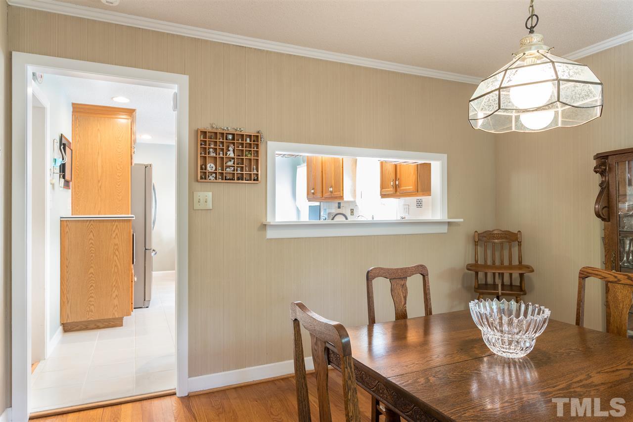 1430 Ridge Road Raleigh, NC 27607 - Photo 14 of 30 a view of a dining room with furniture a chandelier and wooden floor