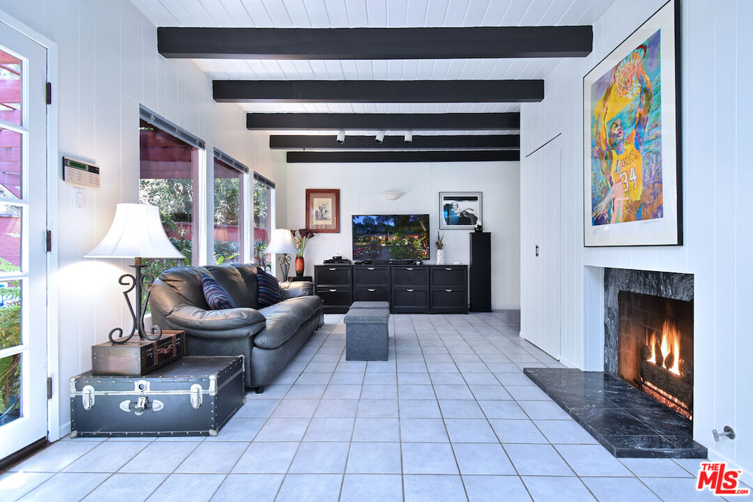 3833 Woodcliff Road Sherman Oaks, CA 91403 - Photo 18 of 52 a living room with furniture and a fireplace