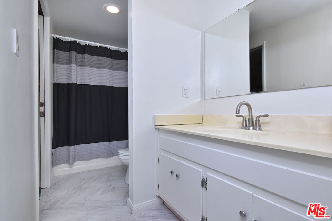 3833 Woodcliff Road Sherman Oaks, CA 91403 - Photo 33 of 52 a bathroom with a sink and a mirror