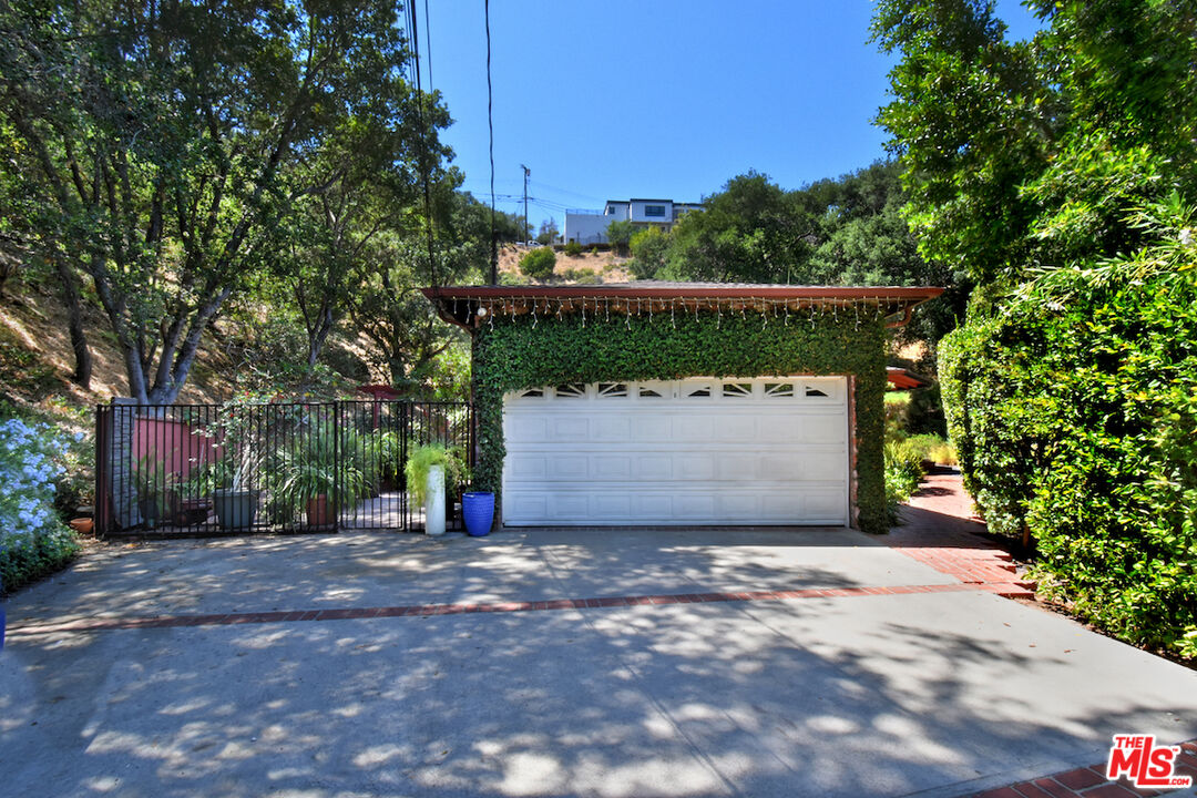 3833 Woodcliff Road Sherman Oaks, CA 91403 - Photo 50 of 52 a view of a house with a tree and a yard