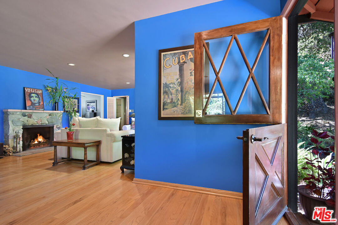 3833 Woodcliff Road Sherman Oaks, CA 91403 - Photo 9 of 52 a living room with furniture a fireplace and a potted plant