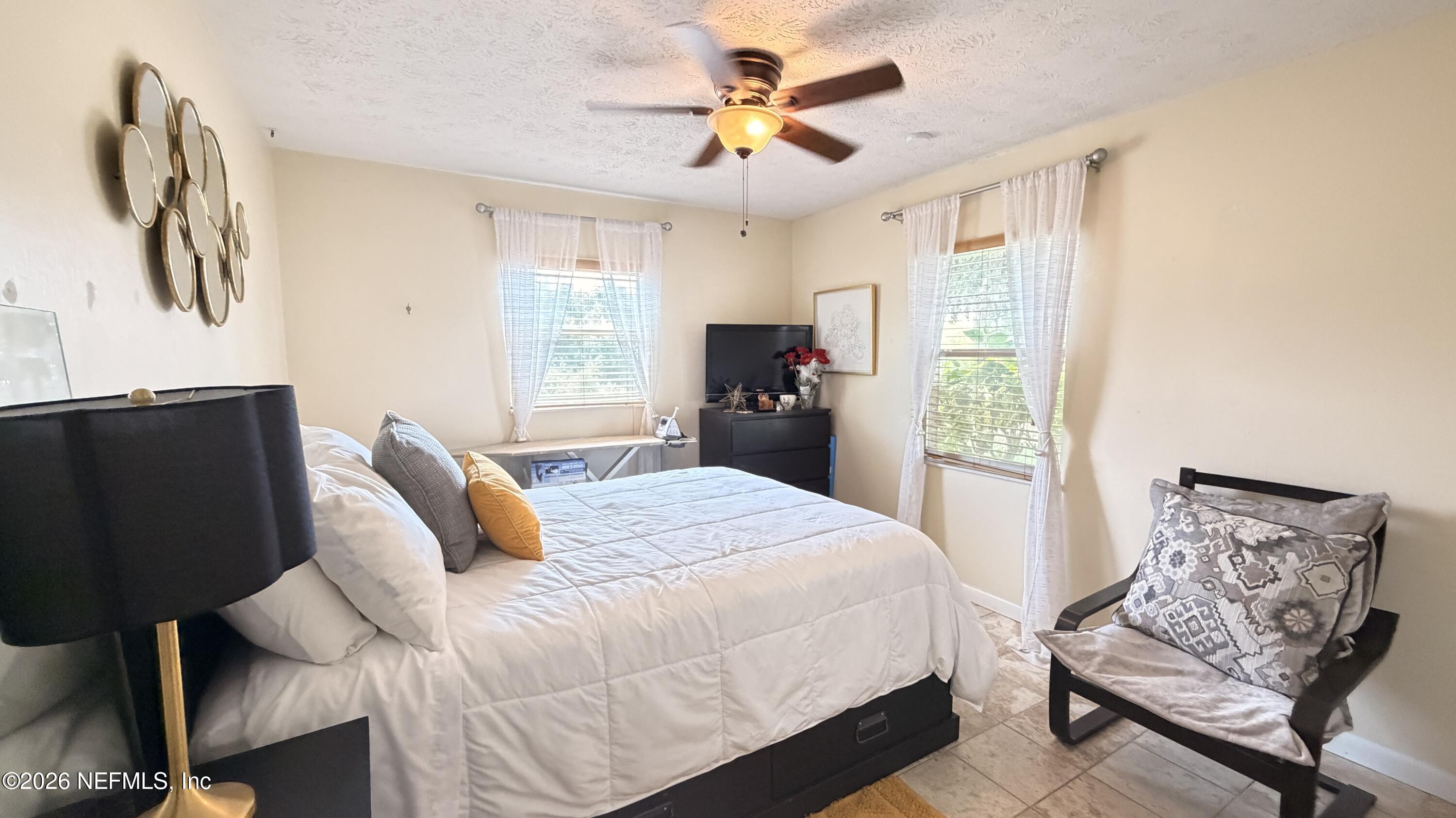 1302 Fort Meade Road Frostproof, FL 33843 - Photo 31 of 39 a bedroom with a bed and a chandelier