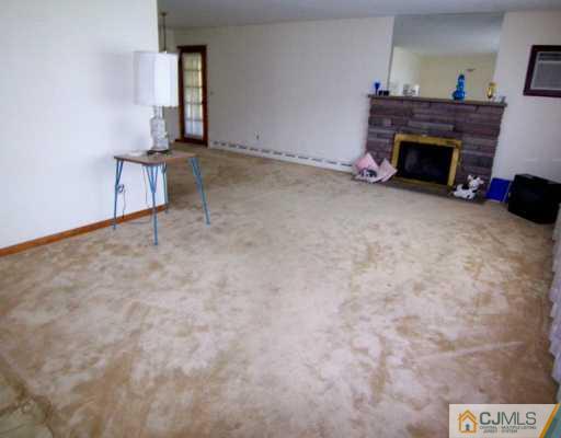 13 Ramsey Road Edison, NJ 08820 - Photo 2 of 8 a view of empty room with fireplace and window