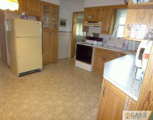 13 Ramsey Road Edison, NJ 08820 - Photo 4 of 8 a kitchen with stainless steel appliances a refrigerator a stove a microwave a sink and cabinets