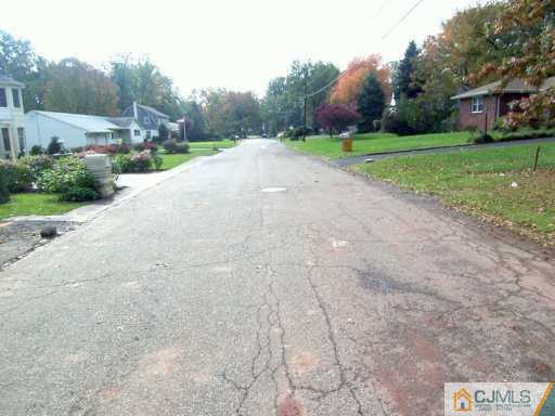 13 Ramsey Road Edison, NJ 08820 - Photo 8 of 8 a view of a road with a house in the background