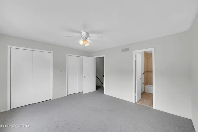 an empty room with large windows