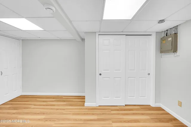 a view of a white house with large windows and a car parked in front of it