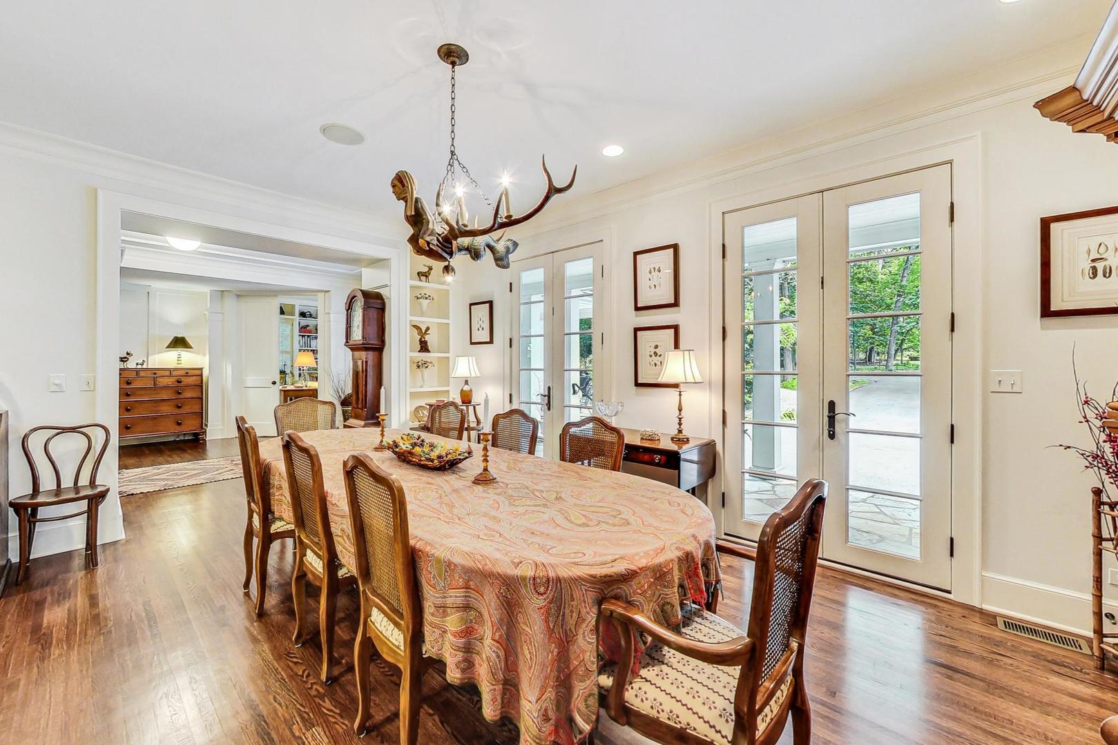 3510 Spring Road Oak Brook, IL 60523 - Photo 6 of 31 a view of a dining room and livingroom with furniture wooden floor a chandelier