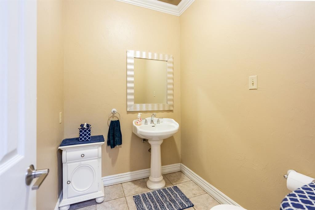 1450 Meandering Way Rockwall, TX 75087 - Photo 26 of 32 a bathroom with a sink and a mirror