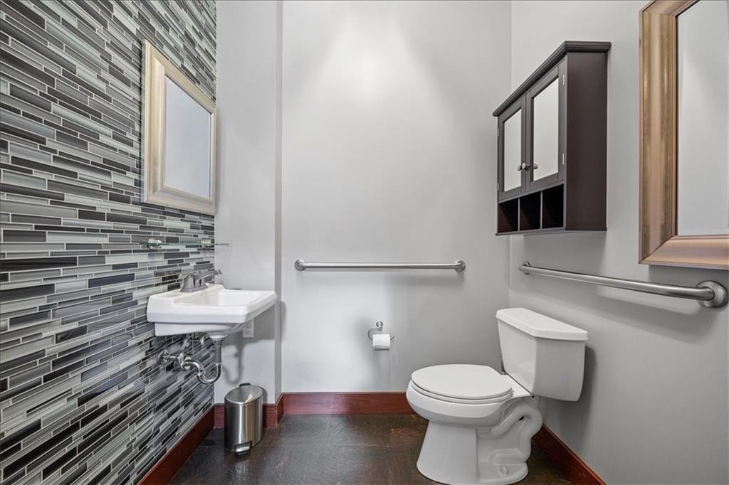 4731 Butler Street Pittsburgh, PA 15201 - Photo 15 of 50 a bathroom with a sink a toilet and a mirror