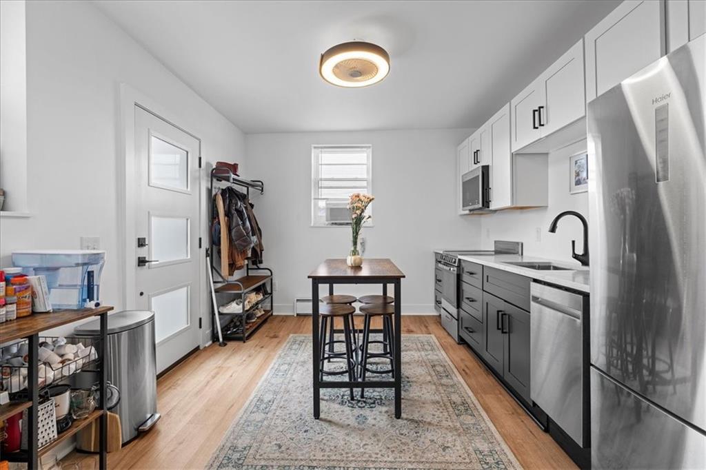 4731 Butler Street Pittsburgh, PA 15201 - Photo 24 of 50 a kitchen with stainless steel appliances granite countertop a stove refrigerator and a sink