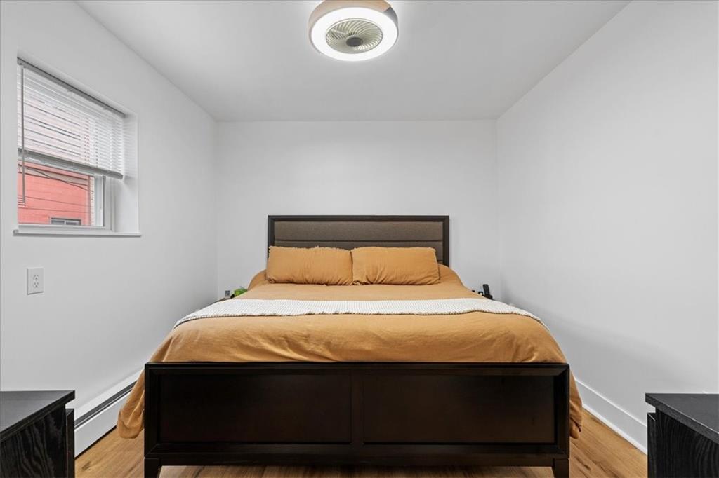 4731 Butler Street Pittsburgh, PA 15201 - Photo 27 of 50 a bedroom with a bed and window