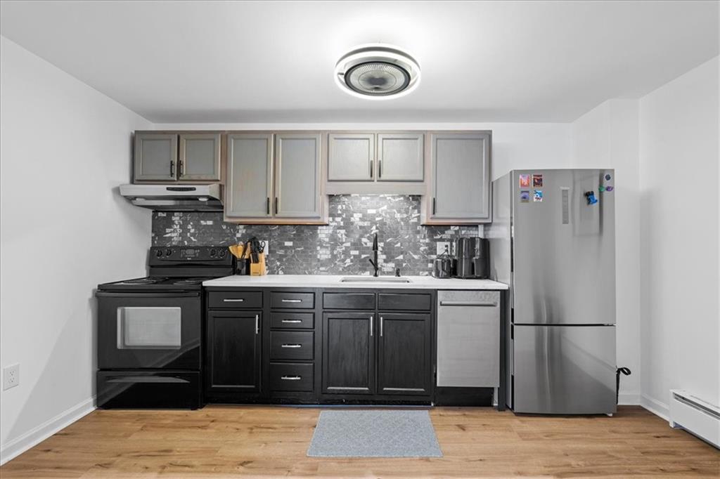 4731 Butler Street Pittsburgh, PA 15201 - Photo 30 of 50 a kitchen with stainless steel appliances granite countertop a refrigerator and a stove top oven