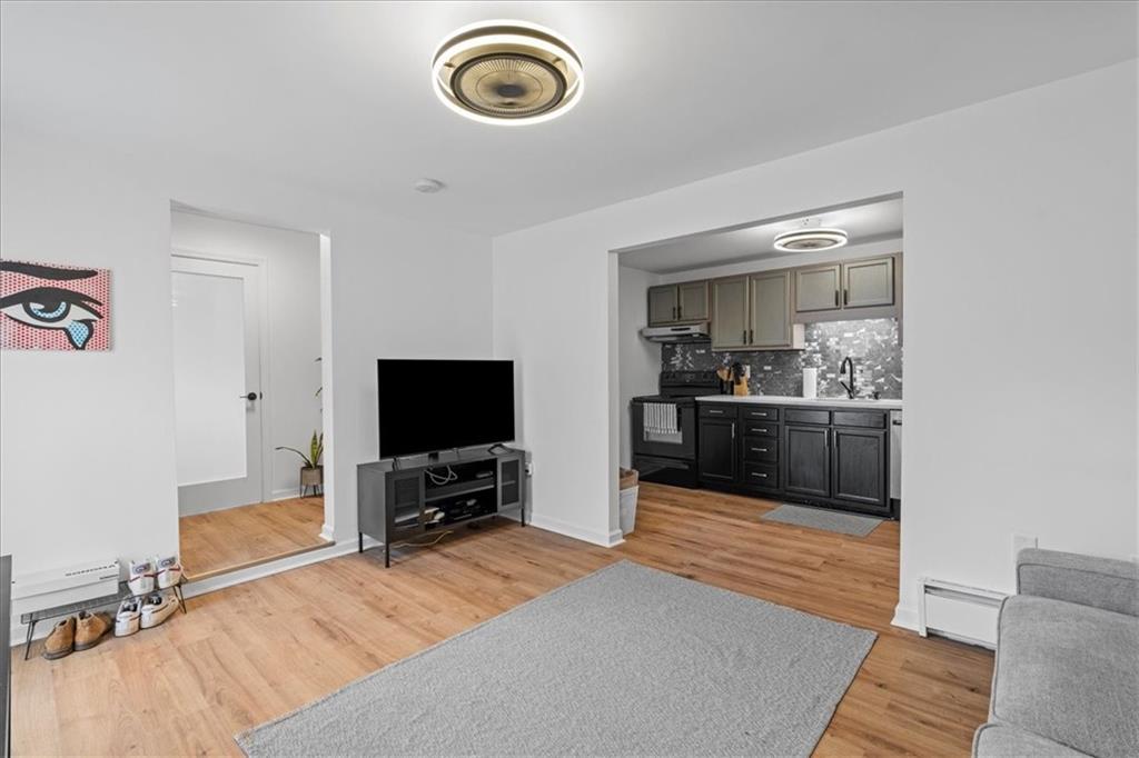 4731 Butler Street Pittsburgh, PA 15201 - Photo 33 of 50 a living room with furniture and a flat screen tv