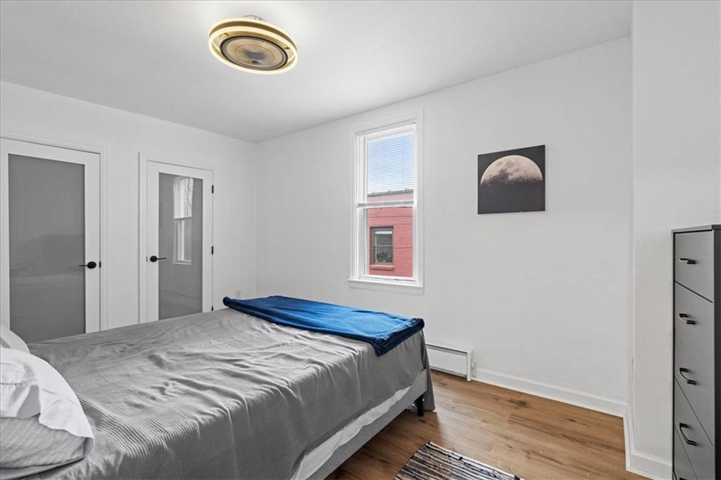 4731 Butler Street Pittsburgh, PA 15201 - Photo 34 of 50 a bedroom with a bed and a window