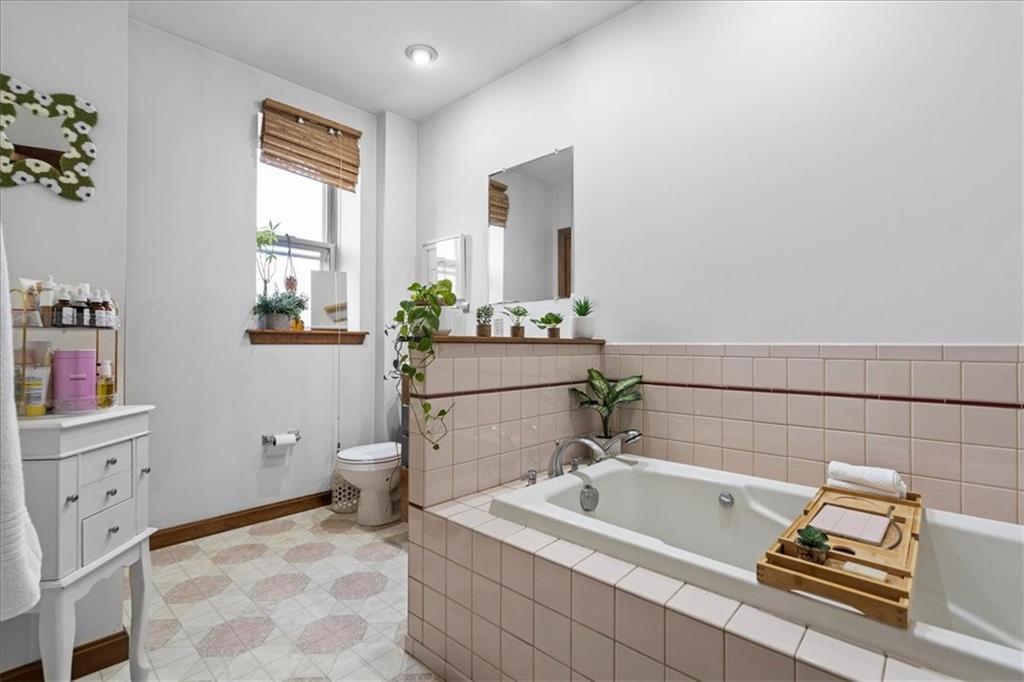 4731 Butler Street Pittsburgh, PA 15201 - Photo 40 of 50 a bathroom with a bathtub sink and toilet