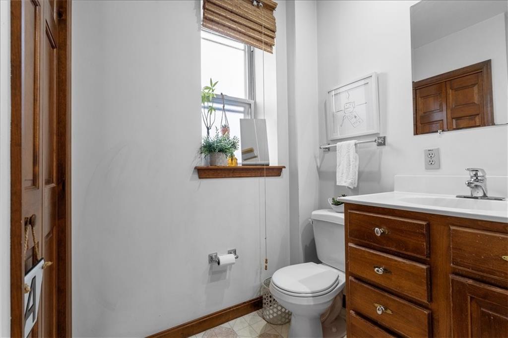 4731 Butler Street Pittsburgh, PA 15201 - Photo 41 of 50 a bathroom with a granite countertop toilet a sink and a window