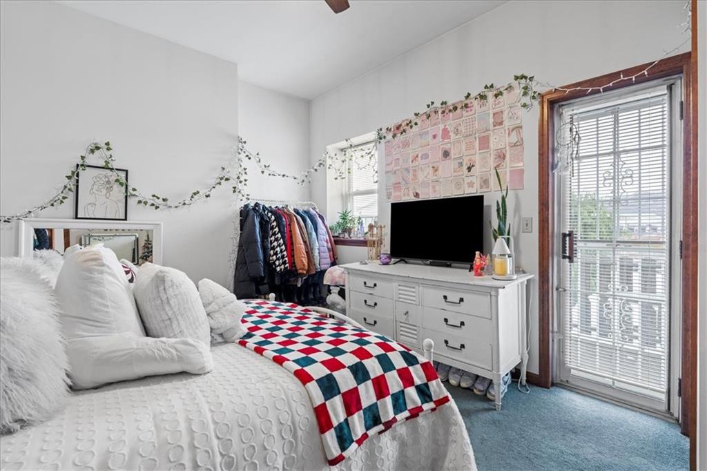 4731 Butler Street Pittsburgh, PA 15201 - Photo 42 of 50 a bedroom with furniture and flat screen tv