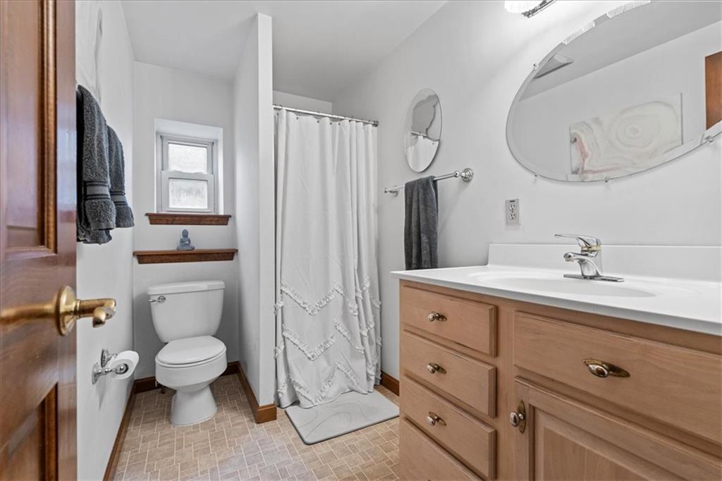 4731 Butler Street Pittsburgh, PA 15201 - Photo 44 of 50 a bathroom with a toilet sink and mirror