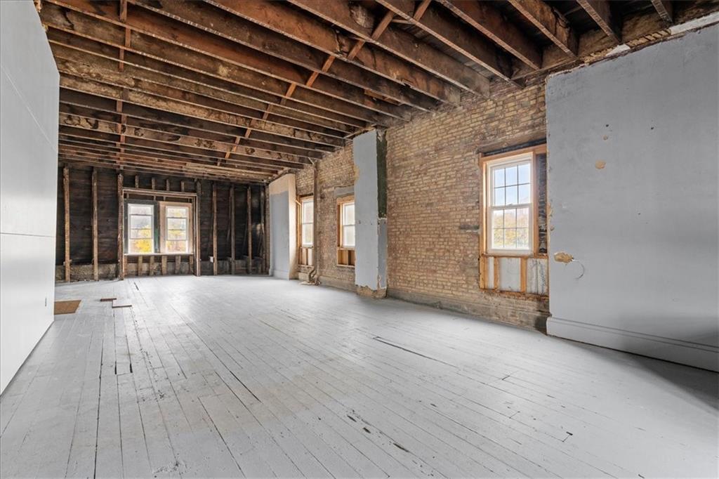 4731 Butler Street Pittsburgh, PA 15201 - Photo 46 of 50 an empty room with wooden floor and windows