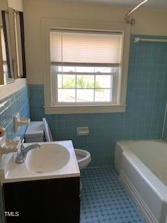 333 Leasburg Road Roxboro, NC 27573 - Photo 8 of 12 a bathroom with a sink a bathtub and a window
