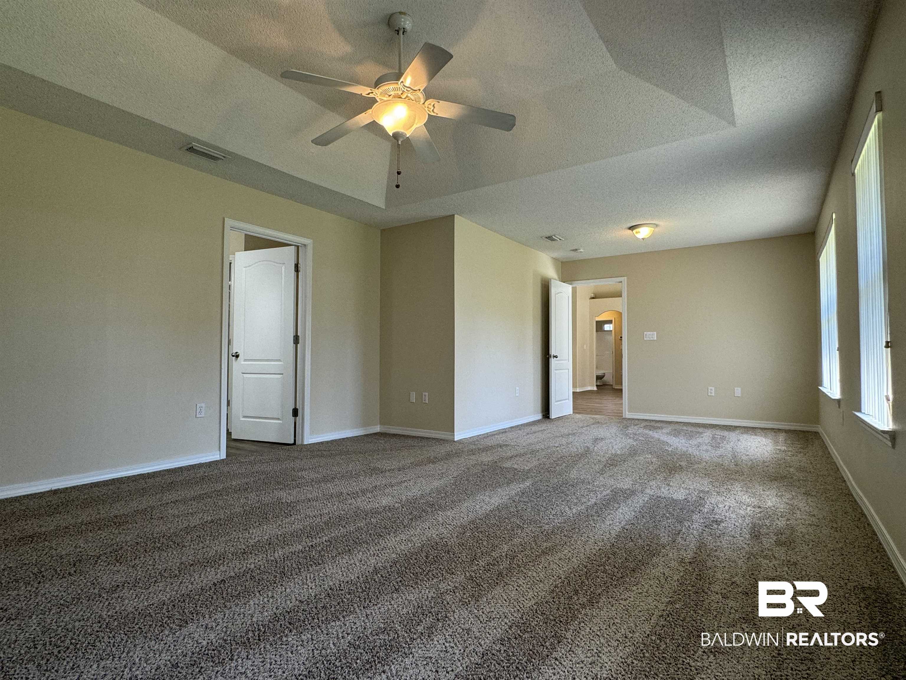 32769 Arbor Ridge Circle Lillian, AL 36549 - Photo 11 of 36 Empty room with ceiling fan, carpet, and a textured ceiling