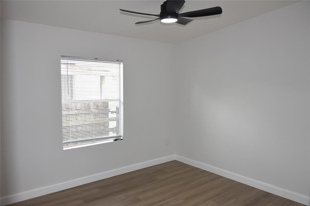 22971 Tradewind Road Boca Raton, FL 33428 - Photo 11 of 13 an empty room with wooden floor closet and windows