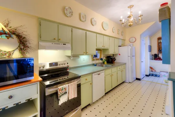 a kitchen with a stove and a white cabinets