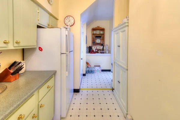 a kitchen with stainless steel appliances a refrigerator and a chandelier