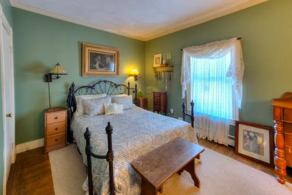 a bedroom with a bed and a table in it