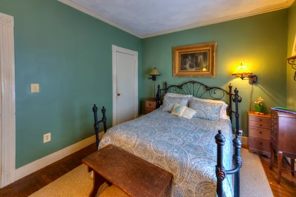 a bedroom with a bed and a chandelier