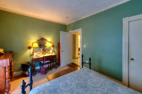 a bed room with a bed and a dresser