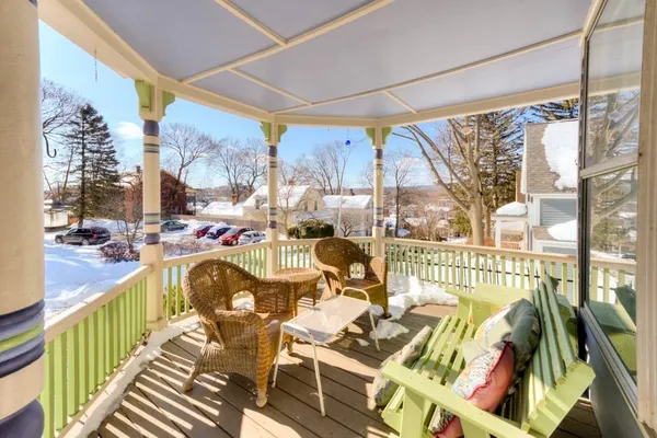 a view of a balcony and dining area with furniture